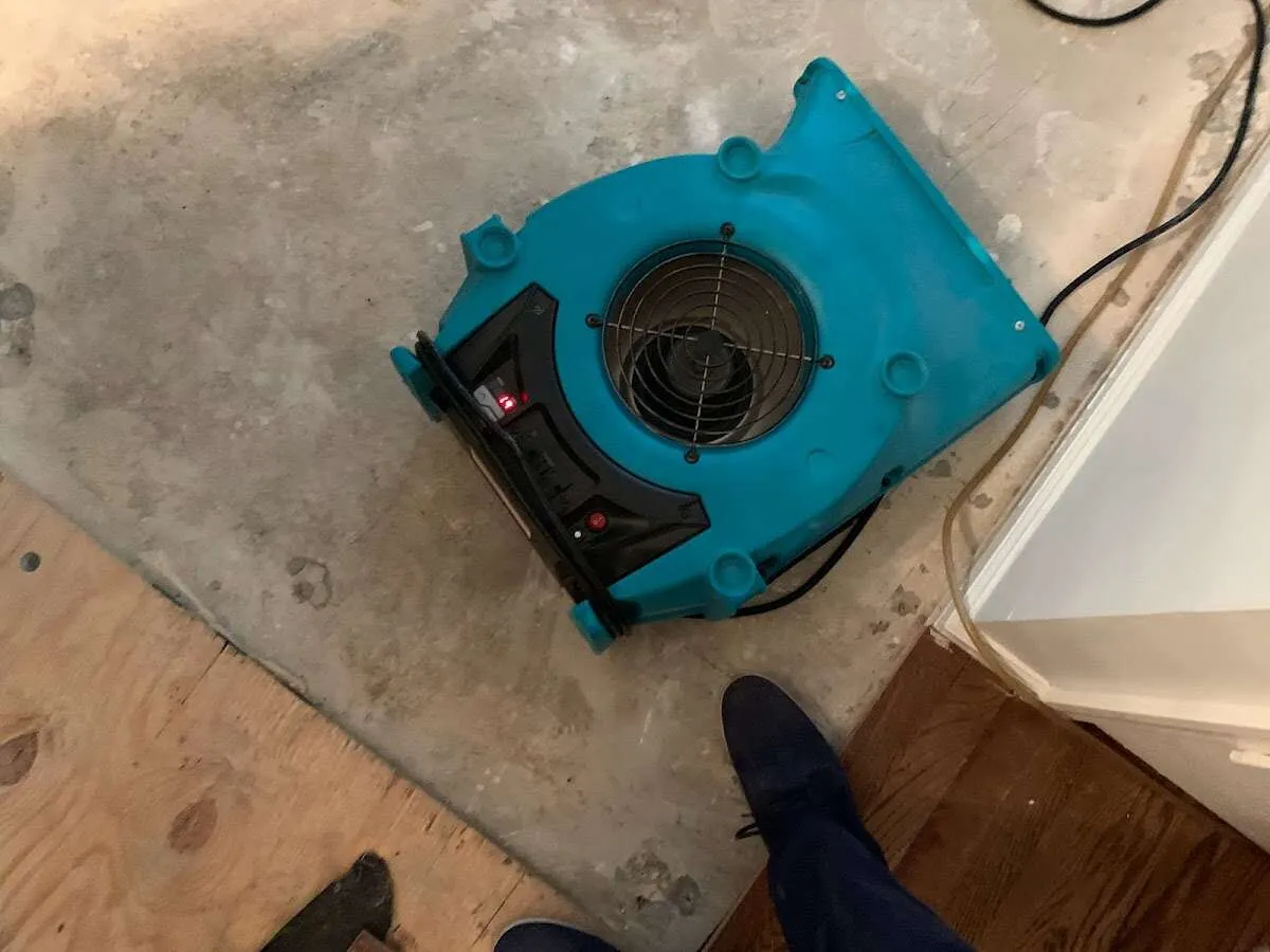 Air mover drying subfloor during Commercial Water Damage Restoration in Norristown